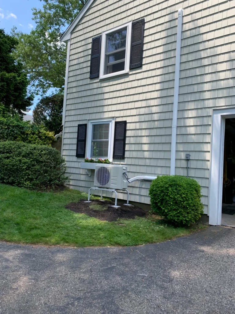 A house with a yard and a lawn with mini split installed