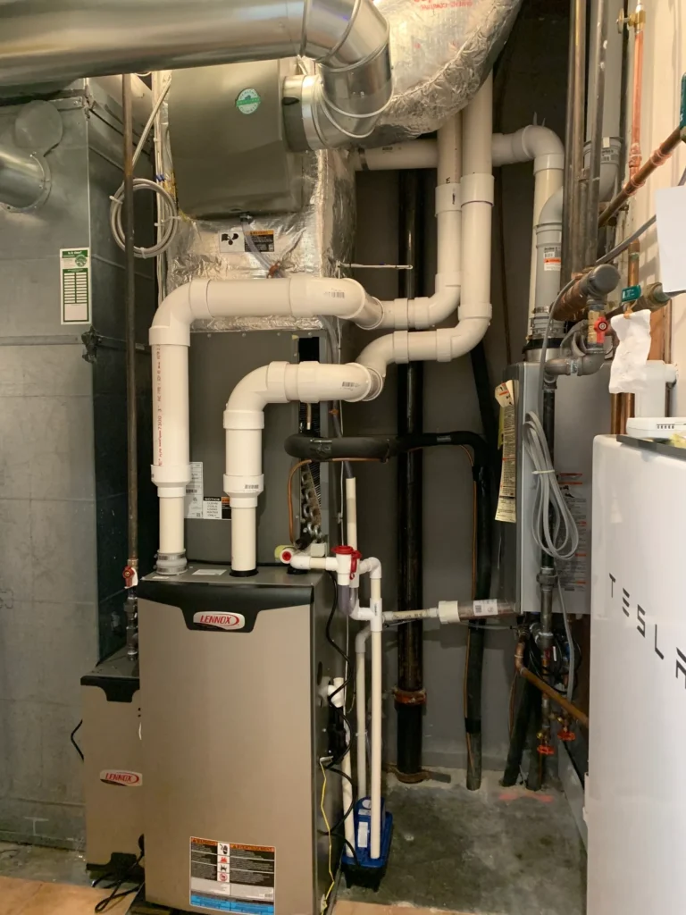 A view of a room with pipes and water heater.