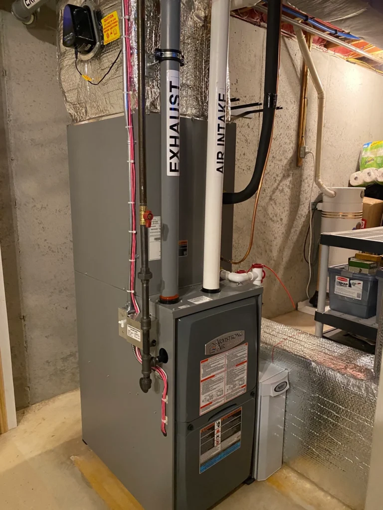 A large gray and black furnace in the middle of a room.